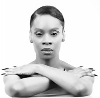 a black and white photo of a woman with her arms crossed