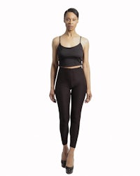 a woman wearing black leggings and a black top