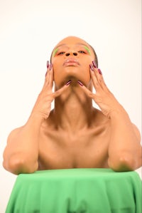 a woman with green makeup on her face