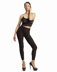 a woman in black leggings posing for a photo