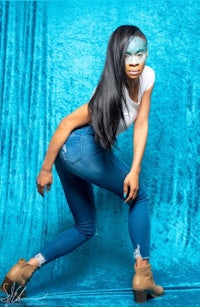 a woman in blue jeans posing for a photo