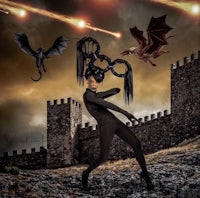 an image of a woman with a dragon on her head in front of a castle